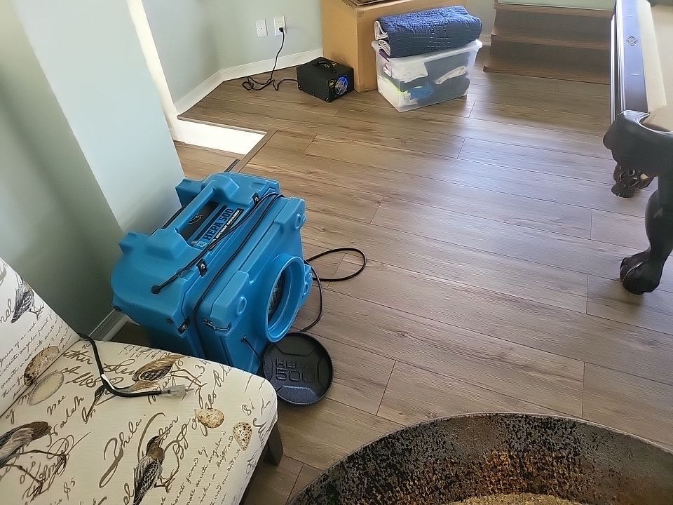 HEPA 500 air scrubber running in living room during water damage restoration